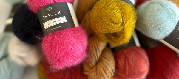 a pile of all sorts of colours and fibres of yarn, ready to be put into the odd ball yarn sale at all about the yarn