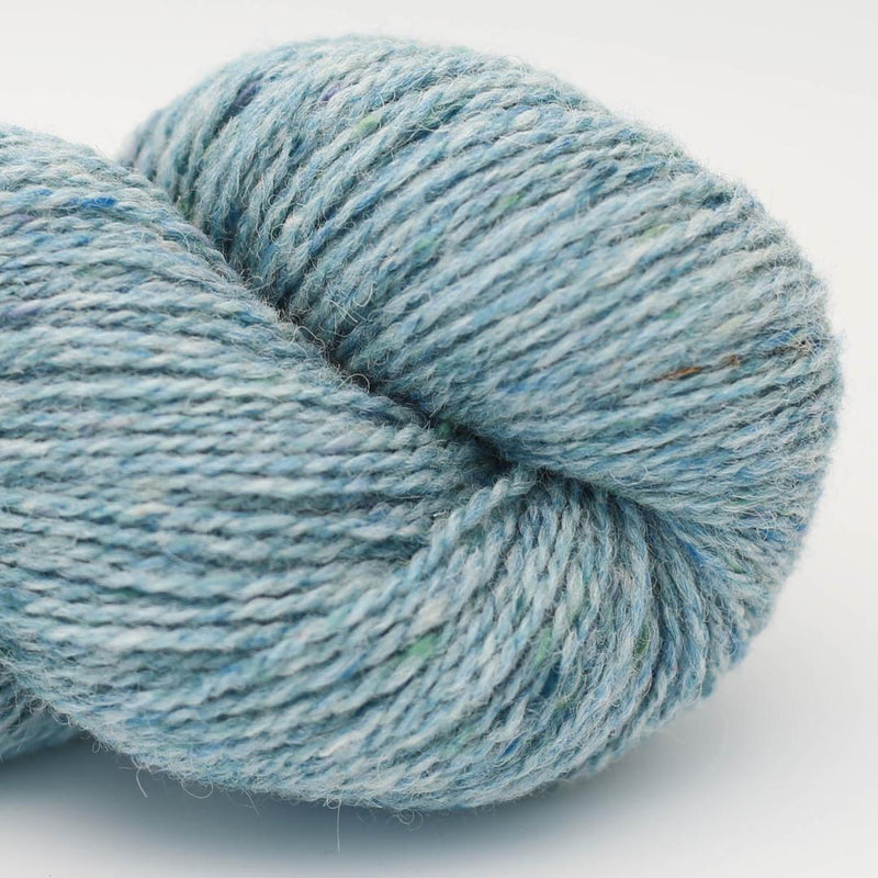 Blue skein of yarn with white and green speckles Beara Irish wool and UK alpaca tweed dk, worsted or aran weight yarn by Hey Mama Wolf 